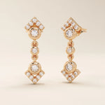 14k solid rose gold dangling arrow stud earrings, showcasing bezel-set moissanites and pavé accents on geometric arrow tips.
