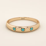 14k solid rose gold dome ring showcasing a trio of aquamarine gemstones accented with engraved star details.