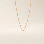 14k solid rose gold dot chain necklace showcasing flat square accents placed at regular intervals, blending warm tones with a contemporary, understated elegance.
