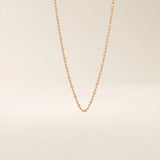 14k solid rose gold dot chain necklace showcasing flat square accents placed at regular intervals, blending warm tones with a contemporary, understated elegance.
