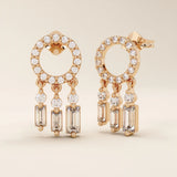 14k solid rose gold dreamcatcher-style stud earrings featuring a pavé-set open circle and three moissanite drop charms.
