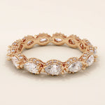 14k solid rose gold eternity ring showcasing sideways pear cut moissanite stones surrounded by pavé set round moissanite accents and ornate milgrain design, romantic fine jewelry gift
