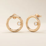 14k solid rose gold karma circle stud earrings with a sleek, polished finish and a single bezel-set round moissanite at the side.
