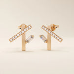 14k solid rose gold modern line studs with a row of sparkling moissanite rounds and a sleek baguette-cut moissanite drop accent.

