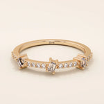 14k solid rose gold ring showcasing three baguette cut moissanite stones interspersed with pavé set round moissanite accents, romantic and contemporary fine jewelry gift
