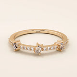 14k solid rose gold ring showcasing three baguette cut moissanite stones interspersed with pavé set round moissanite accents, romantic and contemporary fine jewelry gift
