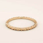 14k solid rose gold slim wedding ring with a continuous marquise-inspired pattern along the band.
