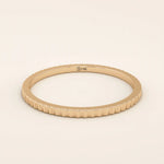 14k solid rose gold thin stacking ring with a faceted textured design, romantic and minimalist fine jewelry piece
