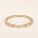 14k solid rose gold thin stacking ring with a faceted textured design, romantic and minimalist fine jewelry piece
