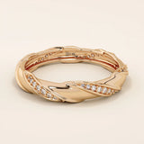 14k solid rose gold twist eternity wedding band with sculpted curves and rows of round brilliant-cut moissanites all around
