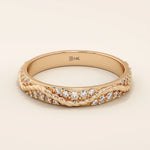 14k solid rose gold twisted eternity wedding band with interwoven strands, fully set with round brilliant-cut moissanites
