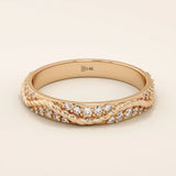 14k solid rose gold twisted eternity wedding band with interwoven strands, fully set with round brilliant-cut moissanites
