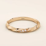 14k solid rose gold twisted wedding band with a cluster of sparkling round moissanites in a marquise-shaped opening, romantic fine jewelry
