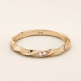 14k solid rose gold twisted wedding band with a cluster of sparkling round moissanites in a marquise-shaped opening, romantic fine jewelry
