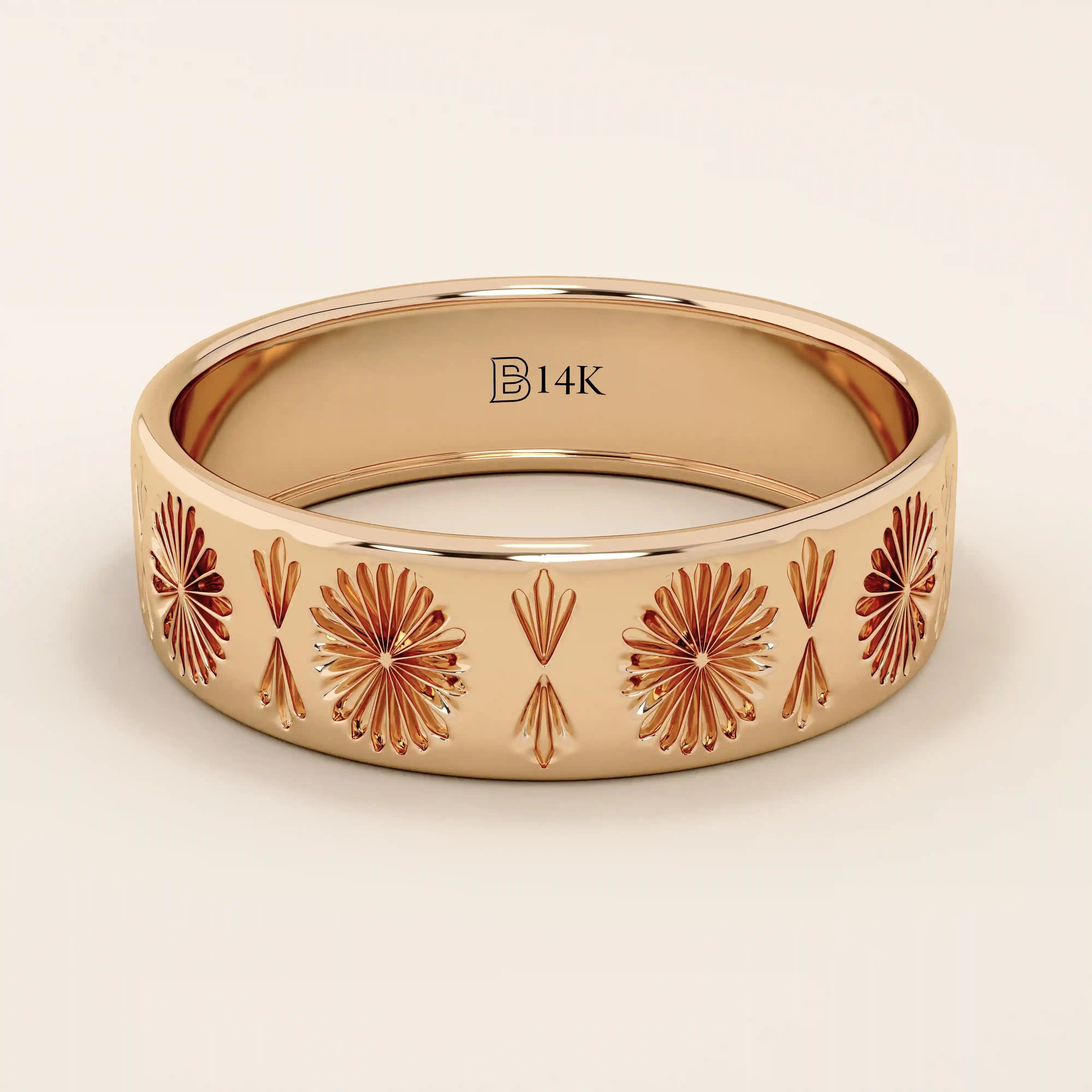 14k solid rose gold wedding band with ornate engraved floral patterns in a repeating design

