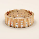 14k solid rose gold wide band showcasing a wood grain texture and pavé set round brilliant cut moissanite stones in varied sizes, romantic and bold fine jewelry piece
