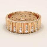 14k solid rose gold wide band showcasing a wood grain texture and pavé set round brilliant cut moissanite stones in varied sizes, romantic and bold fine jewelry piece
