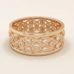 14k solid rose gold wide wedding band with a repeating open lattice pattern, bezel-set moissanite gemstones throughout
