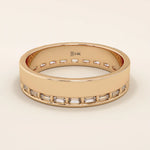 14k solid rose gold wide wedding band with sleek channel-set baguette moissanite stones around the band
