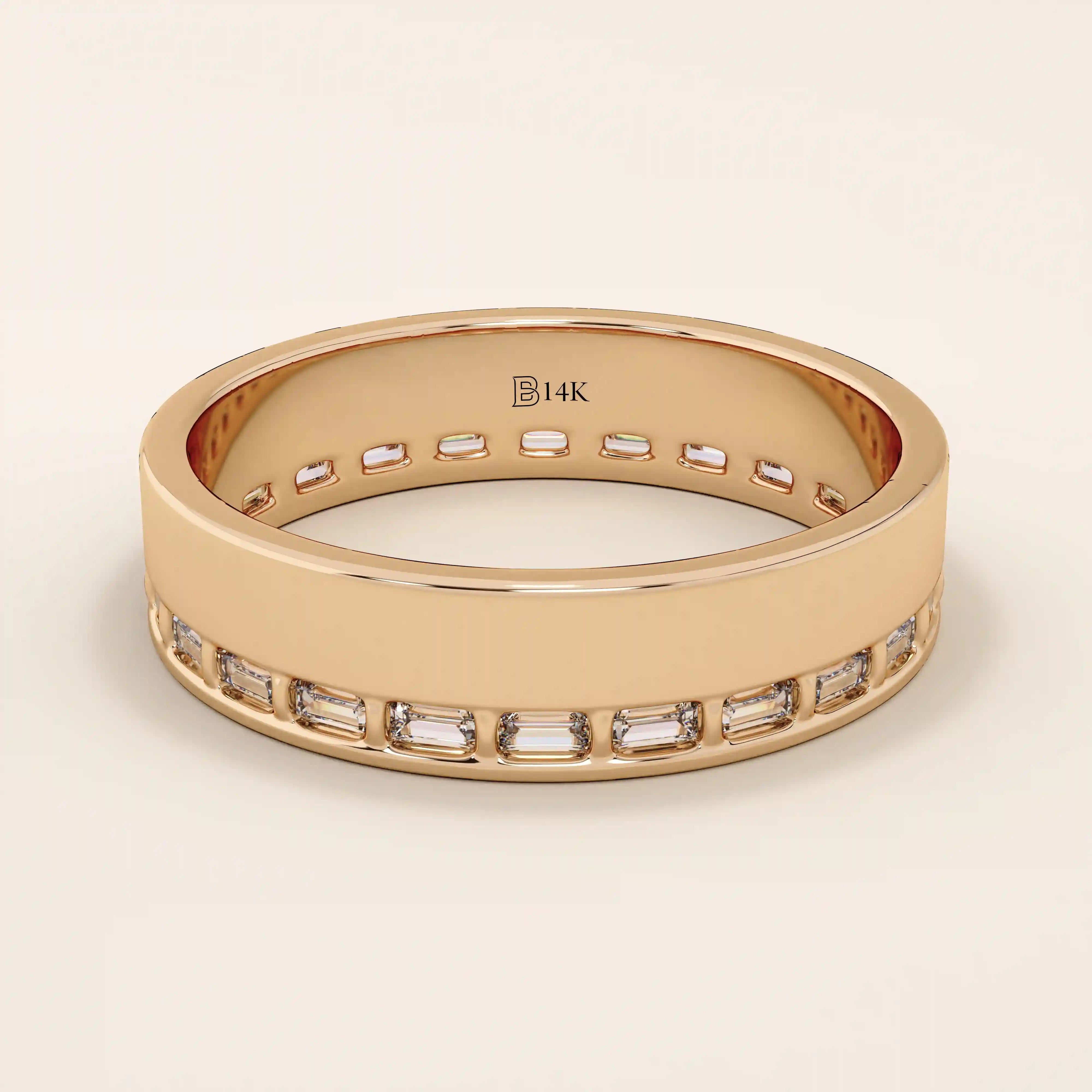 14k solid rose gold wide wedding band with sleek channel-set baguette moissanite stones around the band
