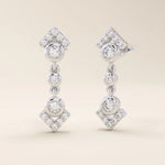 14k solid white gold arrow-inspired drop stud earrings with bezel-set moissanites and pavé-set diamond-shaped tips.
