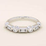 14k solid white gold band with alternating baguette cut and round brilliant cut moissanite stones in a sleek bezel setting, timeless wedding or anniversary ring
