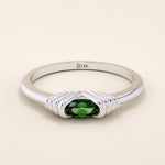 14k solid white gold band with an oval green gemstone set in a sculptural ribbed split mount.
