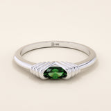 14k solid white gold band with an oval green gemstone set in a sculptural ribbed split mount.
