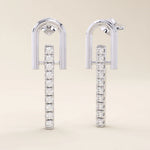 14k solid white gold bar drop stud earrings featuring a curved U-top design and a straight line of sparkling moissanite gems.

