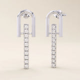 14k solid white gold bar drop stud earrings featuring a curved U-top design and a straight line of sparkling moissanite gems.
