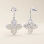 14k solid white gold dangle clover stud earrings with a rope-textured post and a polished four-petal floral drop framed by milgrain details.
