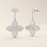 14k solid white gold dangle clover stud earrings with a rope-textured post and a polished four-petal floral drop framed by milgrain details.
