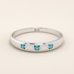 14k solid white gold dome ring with three bright aquamarine stones, each held in star-shaped settings along the band.
