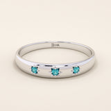14k solid white gold dome ring with three bright aquamarine stones, each held in star-shaped settings along the band.