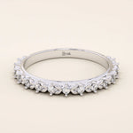 14k solid white gold eternity band featuring round brilliant cut moissanite stones in a delicate leaf-inspired prong setting, elegant stacking ring for wedding or anniversary