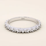 14k solid white gold eternity band featuring round brilliant cut moissanite stones in a delicate leaf-inspired prong setting, elegant stacking ring for wedding or anniversary