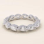 14k solid white gold eternity band with sideways pear cut moissanite stones framed by pavé set round moissanite accents and detailed milgrain edges, elegant wedding or anniversary ring
