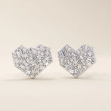 14k solid white gold heart stud earrings with a dazzling arrangement of baguette and round white moissanite stones, creating a brilliant, multi-faceted surface.
