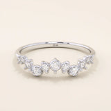 14k solid white gold ring featuring a half-eternity of alternating round moissanite stones in varied sizes.
