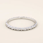 14k solid white gold slim wedding band with an engraved marquise motif encircling the ring.
