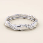 14k solid white gold twisted eternity wedding band, adorned with rows of round brilliant-cut moissanites in a continuous setting
