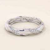 14k solid white gold twisted eternity wedding band, adorned with rows of round brilliant-cut moissanites in a continuous setting

