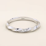 14k solid white gold twisted wedding band featuring a cluster of round brilliant moissanites in a marquise-shaped opening, minimalist and sophisticated style
