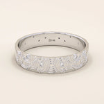 14k solid white gold wedding band featuring a detailed concentric circle motif with bezel-set round moissanites, contemporary artisan style
