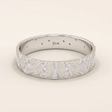 14k solid white gold wedding band featuring a detailed concentric circle motif with bezel-set round moissanites, contemporary artisan style
