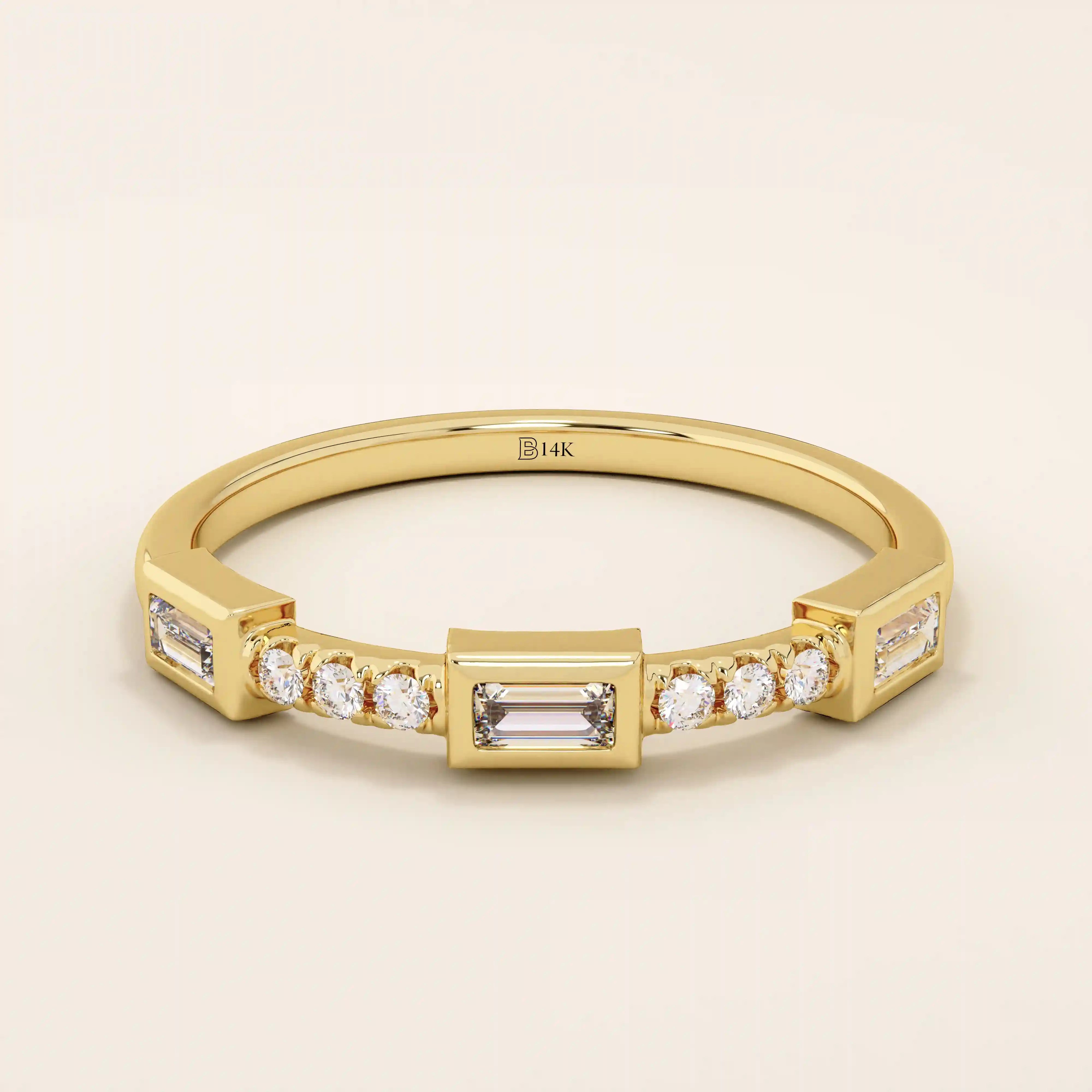 14k solid yellow gold band featuring a baguette cut moissanite center stone flanked by round brilliant cut moissanite accents, modern bezel and prong setting fine jewelry
