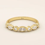 14k solid yellow gold band featuring alternating marquise cut and round brilliant cut moissanite stones in a smooth bezel setting, elegant fine jewelry for weddings or special occasions
