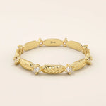 14k solid yellow gold band featuring alternating textured leaf motifs and round moissanite stones.
