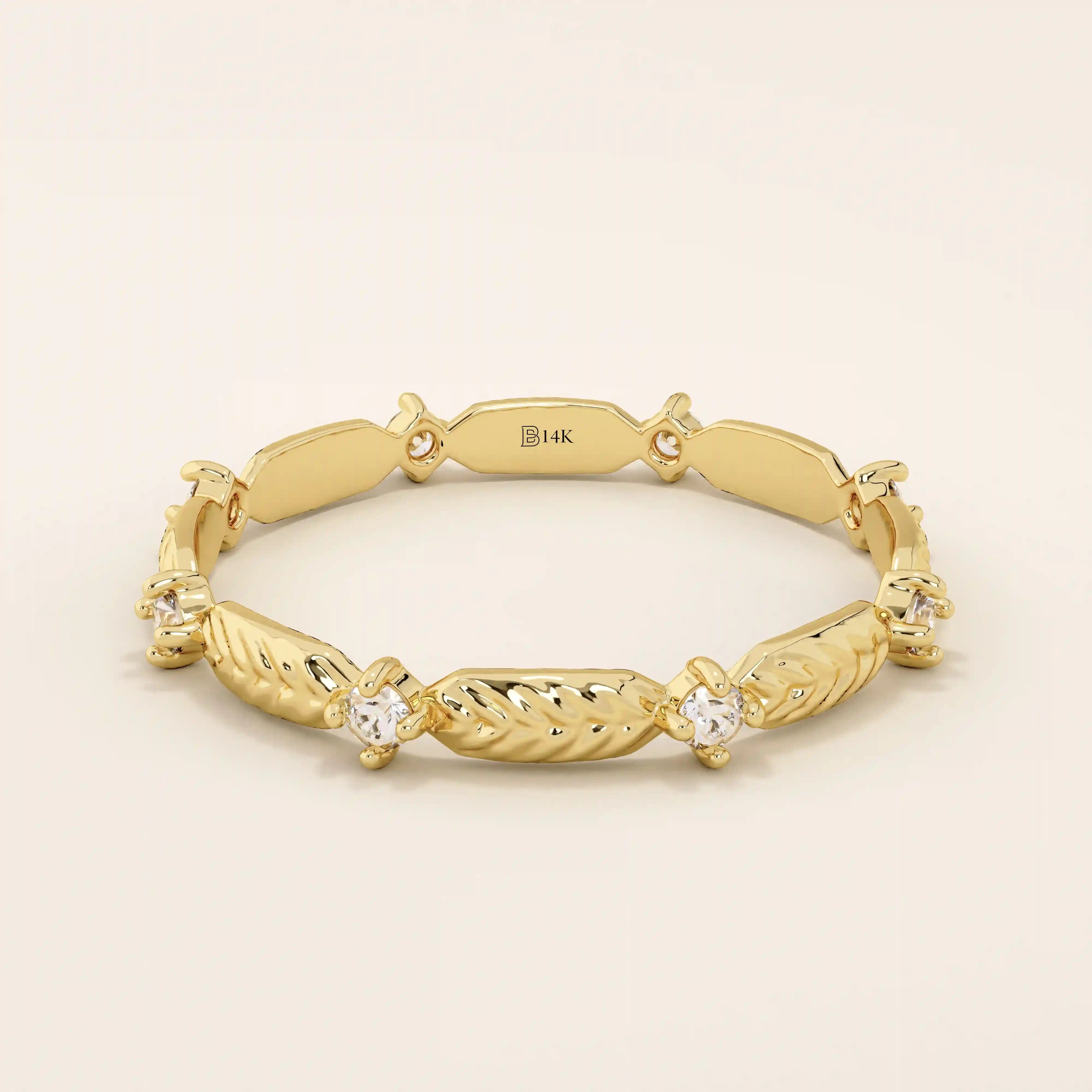 14k solid yellow gold band featuring alternating textured leaf motifs and round moissanite stones.
