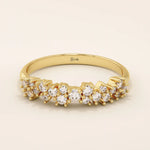 14k solid yellow gold band featuring clusters of round brilliant cut moissanite stones in prong settings, creating a textured and sparkling fine jewelry design for weddings or special occasions
